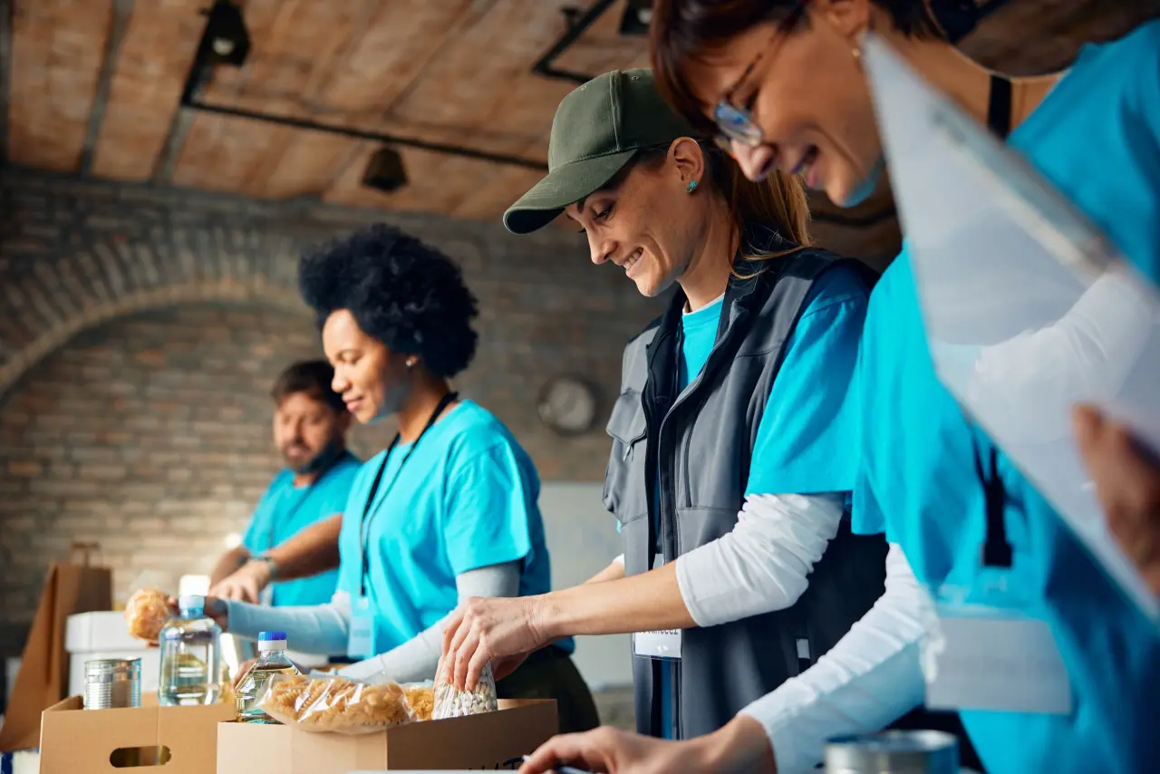 Volunteers packing boxes of food at a community food drive